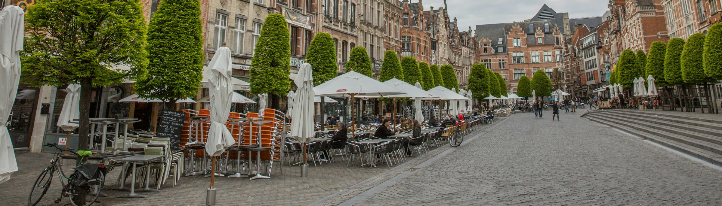 Leuven - Photo by <a href="https://unsplash.com/@liebezz?utm_source=unsplash&utm_medium=referral&utm_content=creditCopyText">kevin liebens</a> on <a href="https://unsplash.com/photos/patio-bistro-sets-near-bulding-Pr1ZTVXJz_8?utm_source=unsplash&utm_medium=referral&utm_content=creditCopyText">Unsplash</a> (modified)